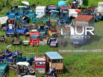 An aerial photo taken on August 22, 2024, shows a large number of cars and motorcycles waiting to be dismantled at a scrap point for discard...