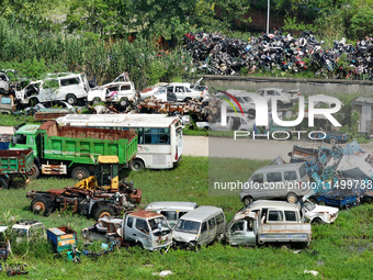 An aerial photo taken on August 22, 2024, shows a large number of cars and motorcycles waiting to be dismantled at a scrap point for discard...