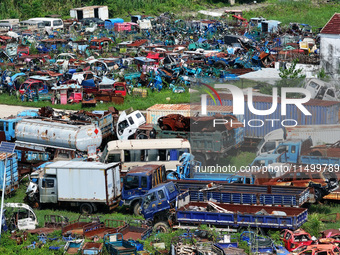 An aerial photo taken on August 22, 2024, shows a large number of cars and motorcycles waiting to be dismantled at a scrap point for discard...