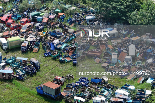 An aerial photo taken on August 22, 2024, shows a large number of cars and motorcycles waiting to be dismantled at a scrap point for discard...