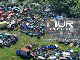 An aerial photo taken on August 22, 2024, shows a large number of cars and motorcycles waiting to be dismantled at a scrap point for discard...