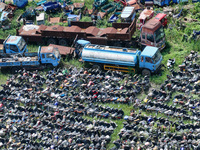 An aerial photo taken on August 22, 2024, shows a large number of cars and motorcycles waiting to be dismantled at a scrap point for discard...