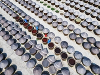 Workers use a wooden rake to turn sauces at the old soy sauce natural drying sauce shop in Yanhe Village, Rucheng Street, Rugao city, East C...