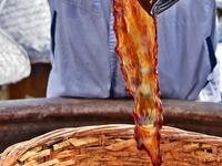 Workers use a wooden rake to turn sauces at the old soy sauce natural drying sauce shop in Yanhe Village, Rucheng Street, Rugao city, East C...