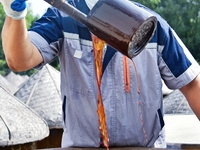 Workers use a wooden rake to turn sauces at the old soy sauce natural drying sauce shop in Yanhe Village, Rucheng Street, Rugao city, East C...