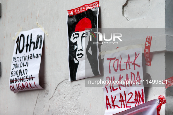 Posters reject the ratification of the Regional Head Election (Pilkada) Bill in front of the West Java DPRD Building in Bandung, Indonesia,...