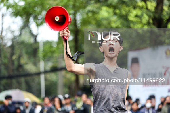 A student gives a speech during a demonstration to reject the ratification of the Regional Head Election (Pilkada) Bill in front of the West...