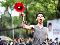 A student gives a speech during a demonstration to reject the ratification of the Regional Head Election (Pilkada) Bill in front of the West...