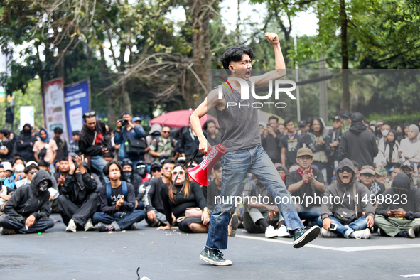 A student gives a speech during a demonstration to reject the ratification of the Regional Head Election (Pilkada) Bill in front of the West...