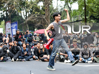 A student gives a speech during a demonstration to reject the ratification of the Regional Head Election (Pilkada) Bill in front of the West...