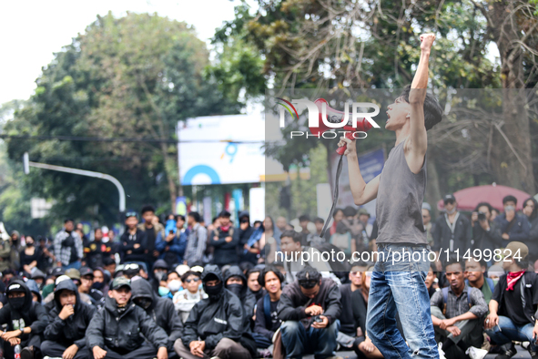 A student gives a speech during a demonstration to reject the ratification of the Regional Head Election (Pilkada) Bill in front of the West...