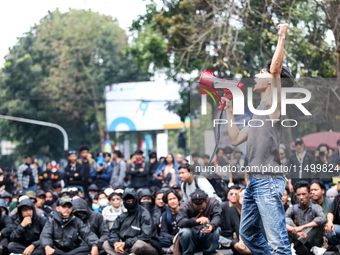 A student gives a speech during a demonstration to reject the ratification of the Regional Head Election (Pilkada) Bill in front of the West...