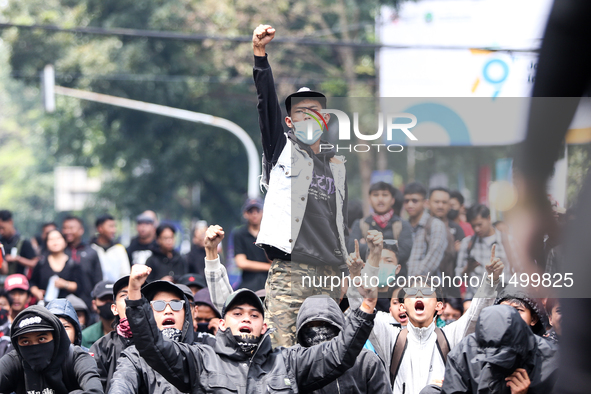 Students shout during a demonstration to reject the ratification of the Regional Head Election (Pilkada) Bill in front of the West Java DPRD...