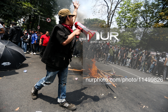 A student gives a speech during a demonstration to reject the ratification of the Regional Head Election (Pilkada) Bill in front of the West...