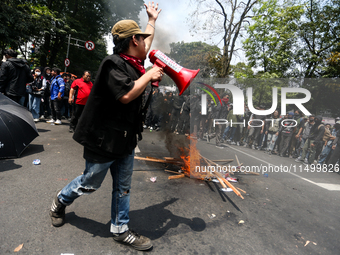 A student gives a speech during a demonstration to reject the ratification of the Regional Head Election (Pilkada) Bill in front of the West...