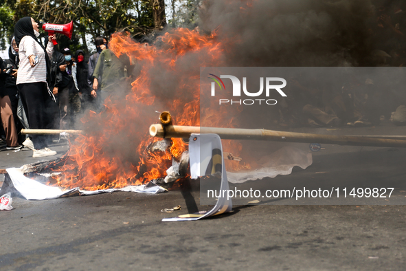 A student gives a speech during a demonstration to reject the ratification of the Regional Head Election (Pilkada) Bill in front of the West...