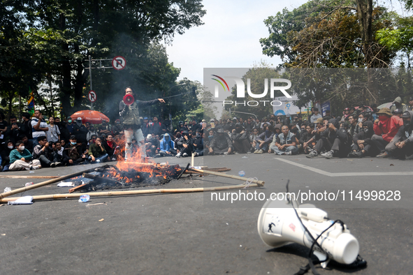 A student gives a speech during a demonstration to reject the ratification of the Regional Head Election (Pilkada) Bill in front of the West...