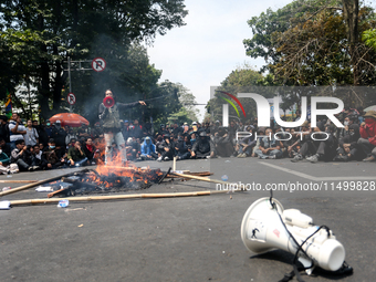 A student gives a speech during a demonstration to reject the ratification of the Regional Head Election (Pilkada) Bill in front of the West...