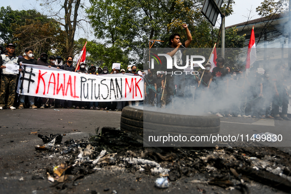 A student gives a speech during a demonstration to reject the ratification of the Regional Head Election (Pilkada) Bill in front of the West...