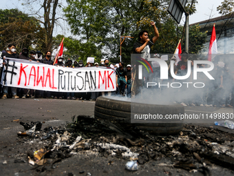 A student gives a speech during a demonstration to reject the ratification of the Regional Head Election (Pilkada) Bill in front of the West...