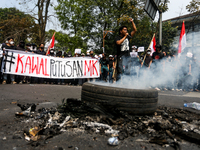 A student gives a speech during a demonstration to reject the ratification of the Regional Head Election (Pilkada) Bill in front of the West...