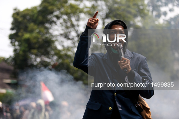 A student gives a speech during a demonstration to reject the ratification of the Regional Head Election (Pilkada) Bill in front of the West...