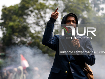 A student gives a speech during a demonstration to reject the ratification of the Regional Head Election (Pilkada) Bill in front of the West...