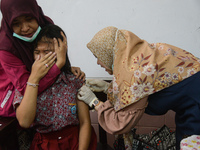 A health worker injects a dose of the Human Papilloma Virus (HPV) vaccine into a schoolgirl's arm during the Immunization Month for School C...