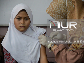 A schoolgirl receives a dose of the Human Papilloma Virus (HPV) vaccine during the Immunization Month for School Children (BIAS) 2024 at an...