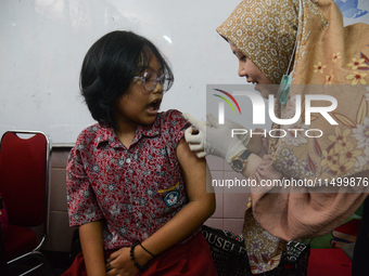 A schoolgirl receives a dose of the Human Papilloma Virus (HPV) vaccine during the Immunization Month for School Children (BIAS) 2024 at an...