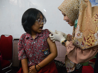 A schoolgirl receives a dose of the Human Papilloma Virus (HPV) vaccine during the Immunization Month for School Children (BIAS) 2024 at an...