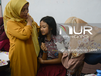 A health worker injects a dose of the Human Papilloma Virus (HPV) vaccine into a schoolgirl's arm during the Immunization Month for School C...