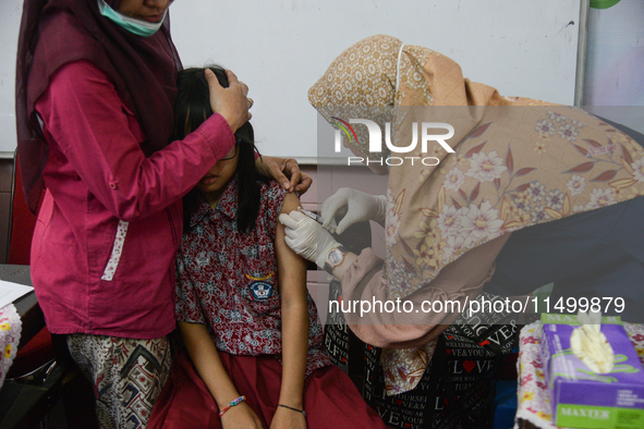 A schoolgirl receives a dose of the Human Papilloma Virus (HPV) vaccine during the Immunization Month for School Children (BIAS) 2024 at an...