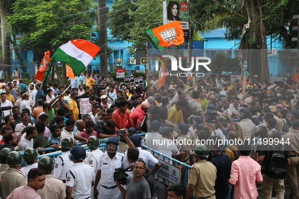 Bharatiya Janata Party (BJP) participates in a protest rally marching to the Health Headquarters and crosses the police barricade in protest...