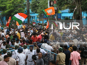 Bharatiya Janata Party (BJP) participates in a protest rally marching to the Health Headquarters and crosses the police barricade in protest...