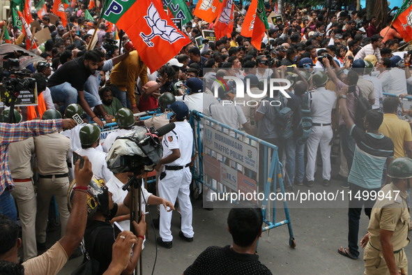 Bharatiya Janata Party (BJP) participates in a protest rally marching to the Health Headquarters and crosses the police barricade in protest...