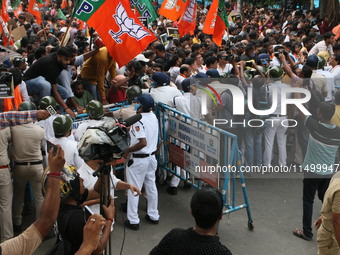 Bharatiya Janata Party (BJP) participates in a protest rally marching to the Health Headquarters and crosses the police barricade in protest...