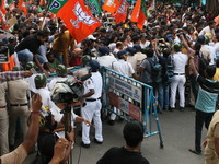 Bharatiya Janata Party (BJP) participates in a protest rally marching to the Health Headquarters and crosses the police barricade in protest...