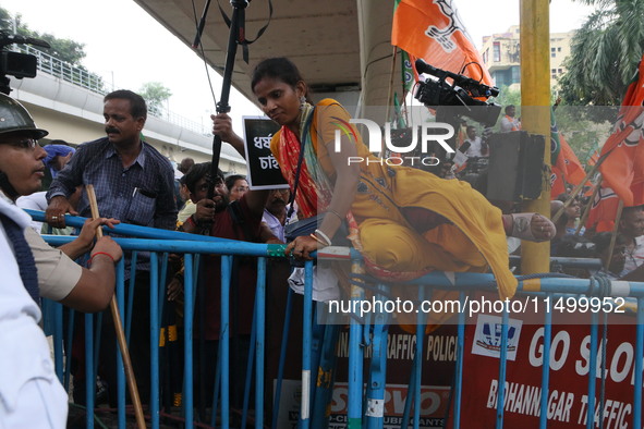 Bharatiya Janata Party (BJP) participates in a protest rally marching to the Health Headquarters and crosses the police barricade in protest...