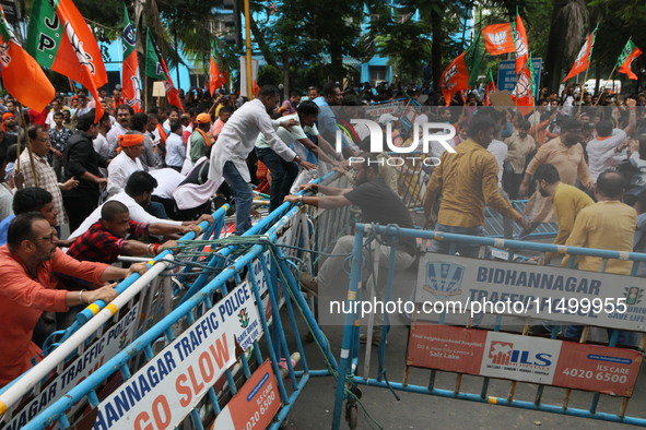 Bharatiya Janata Party (BJP) participates in a protest rally marching to the Health Headquarters and crosses the police barricade in protest...