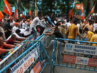 Bharatiya Janata Party (BJP) participates in a protest rally marching to the Health Headquarters and crosses the police barricade in protest...