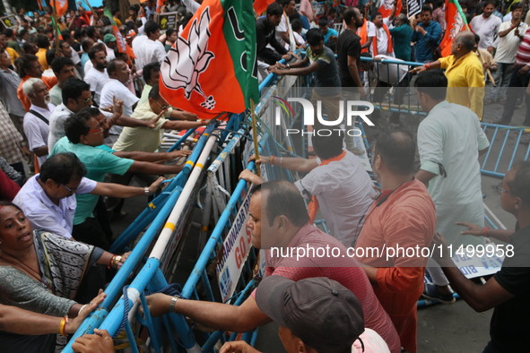 Bharatiya Janata Party (BJP) participates in a protest rally marching to the Health Headquarters and crosses the police barricade in protest...