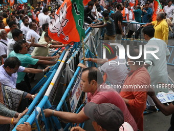 Bharatiya Janata Party (BJP) participates in a protest rally marching to the Health Headquarters and crosses the police barricade in protest...