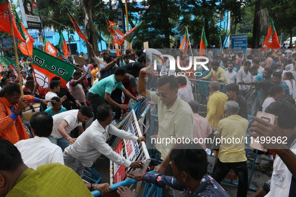 Bharatiya Janata Party (BJP) participates in a protest rally marching to the Health Headquarters and crosses the police barricade in protest...