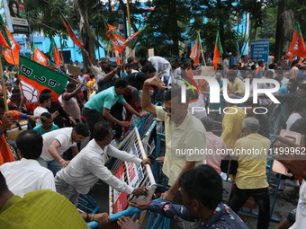 Bharatiya Janata Party (BJP) participates in a protest rally marching to the Health Headquarters and crosses the police barricade in protest...