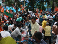 Bharatiya Janata Party (BJP) participates in a protest rally marching to the Health Headquarters and crosses the police barricade in protest...