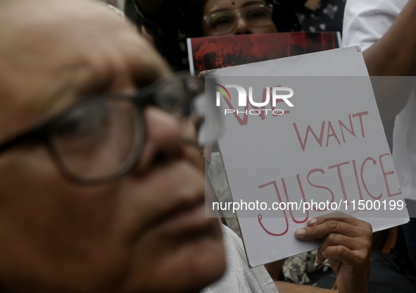 Artist professionals shout slogans and hold placards as part of a protest against the rape and murder of a trainee medic at a government-run...