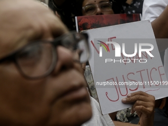 Artist professionals shout slogans and hold placards as part of a protest against the rape and murder of a trainee medic at a government-run...