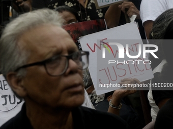 Artist professionals shout slogans and hold placards as part of a protest against the rape and murder of a trainee medic at a government-run...