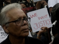 Artist professionals shout slogans and hold placards as part of a protest against the rape and murder of a trainee medic at a government-run...